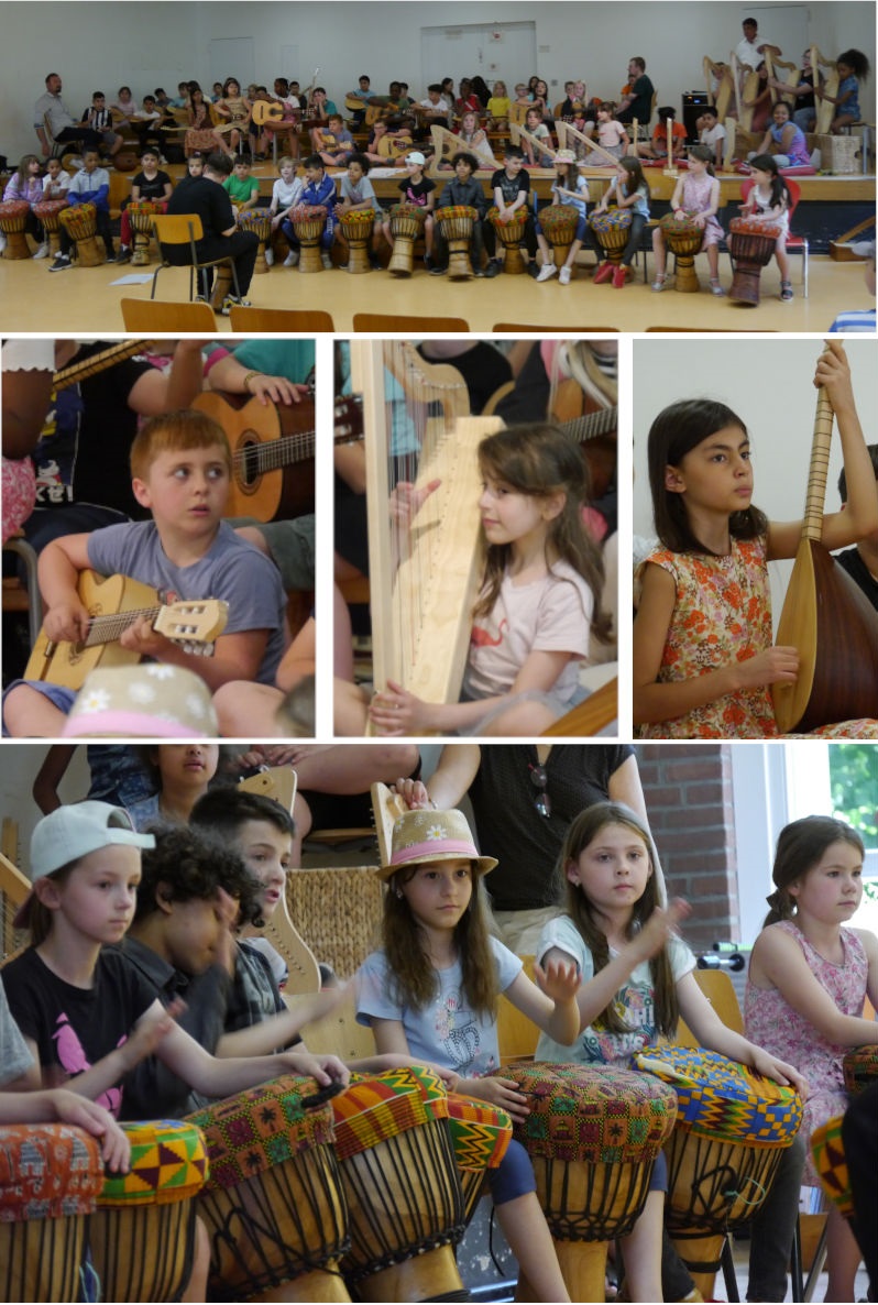 Kinder musizieren auf der B&uuml;hne mit Saz, Trommeln, Gitarren, Harfen und Ukulelen