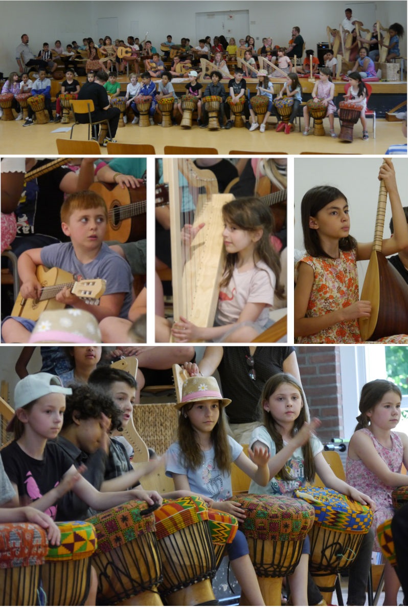 Kinder musizieren auf der Bühne mit Saz, Trommeln, Gitarren, Harfen und Ukulelen